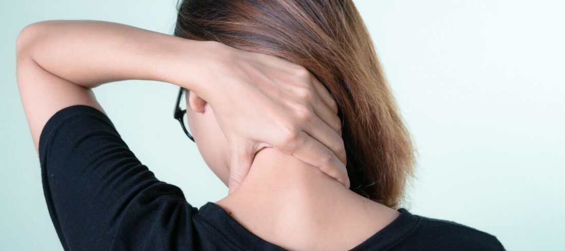 A Woman Holding her Neck
