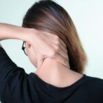 A Woman Holding her Neck