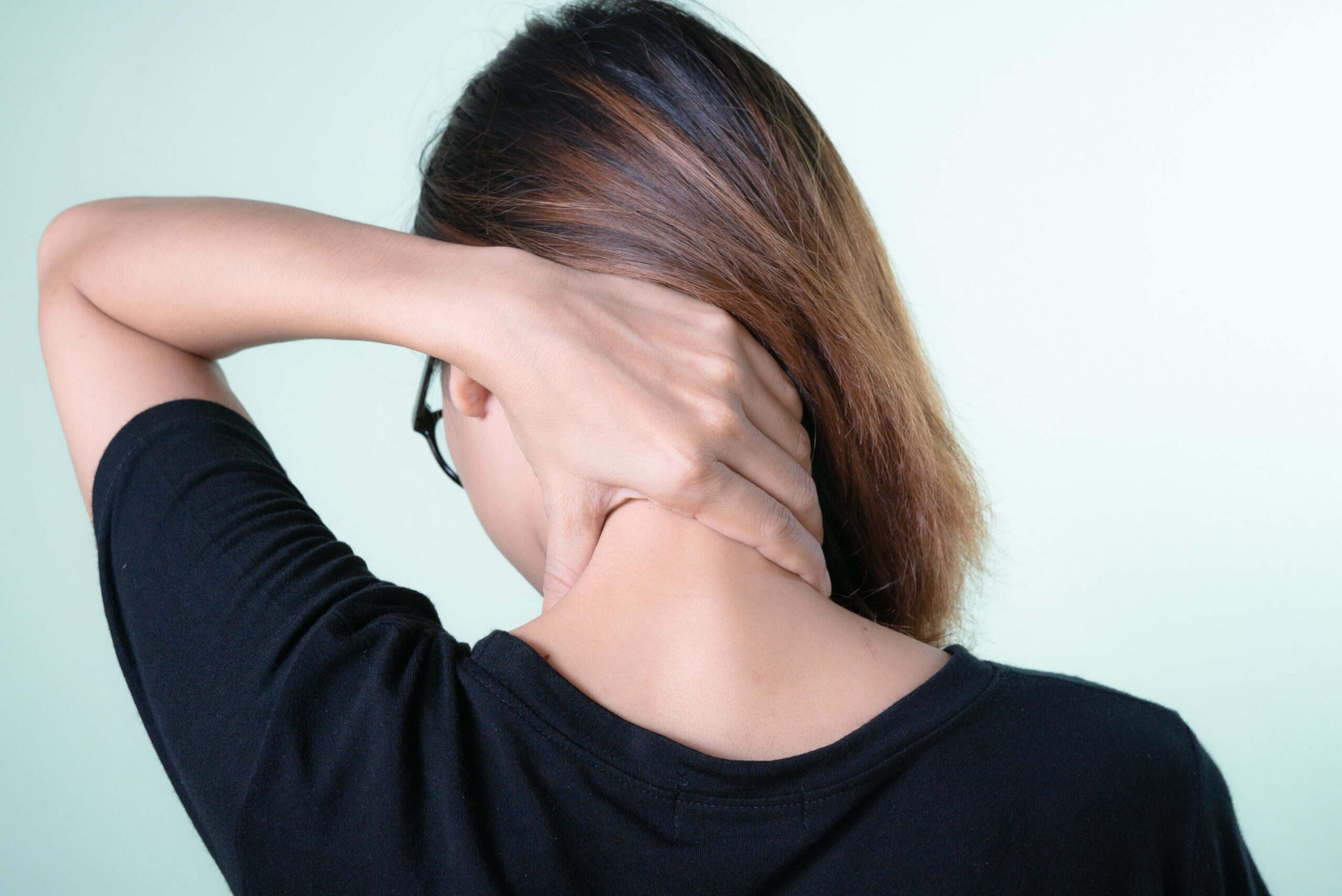 A Woman Holding her Neck